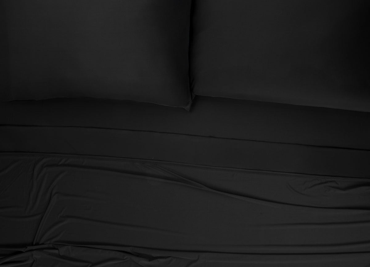 Nightfall Sheets and Pillowcases on a bed shown in Black Eclipse #choose-your-color_black-eclipse