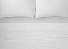 Nightfall Sheets and Pillowcases on a bed shown in Cloud White #choose-your-color_cloud-white