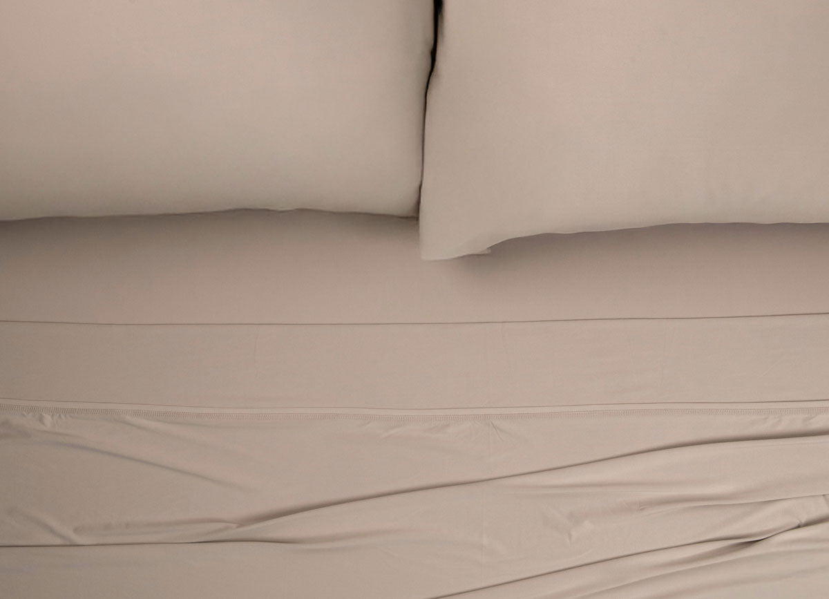Nightfall Sheets and Pillowcases on a bed shown in Sand Dune #choose-your-color_sand-dune