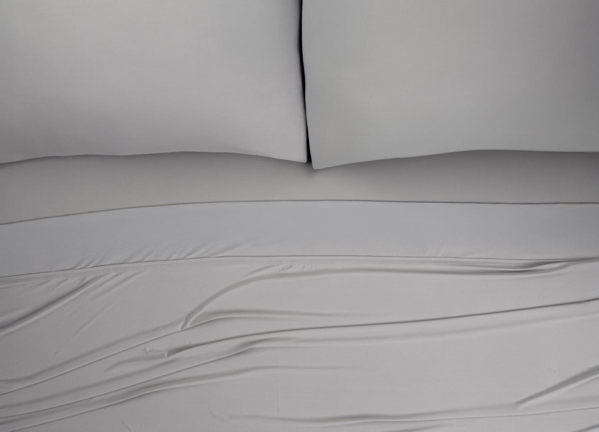 Nightfall Sheets and Pillowcases on a bed shown in Silver Dusk #choose-your-color_silver-dusk