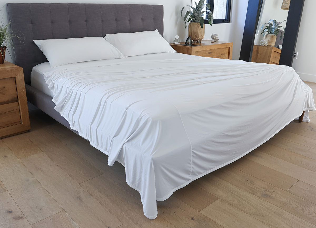 Bright White sheet set shown on bed in bedroom environment. #choose-your-color_white