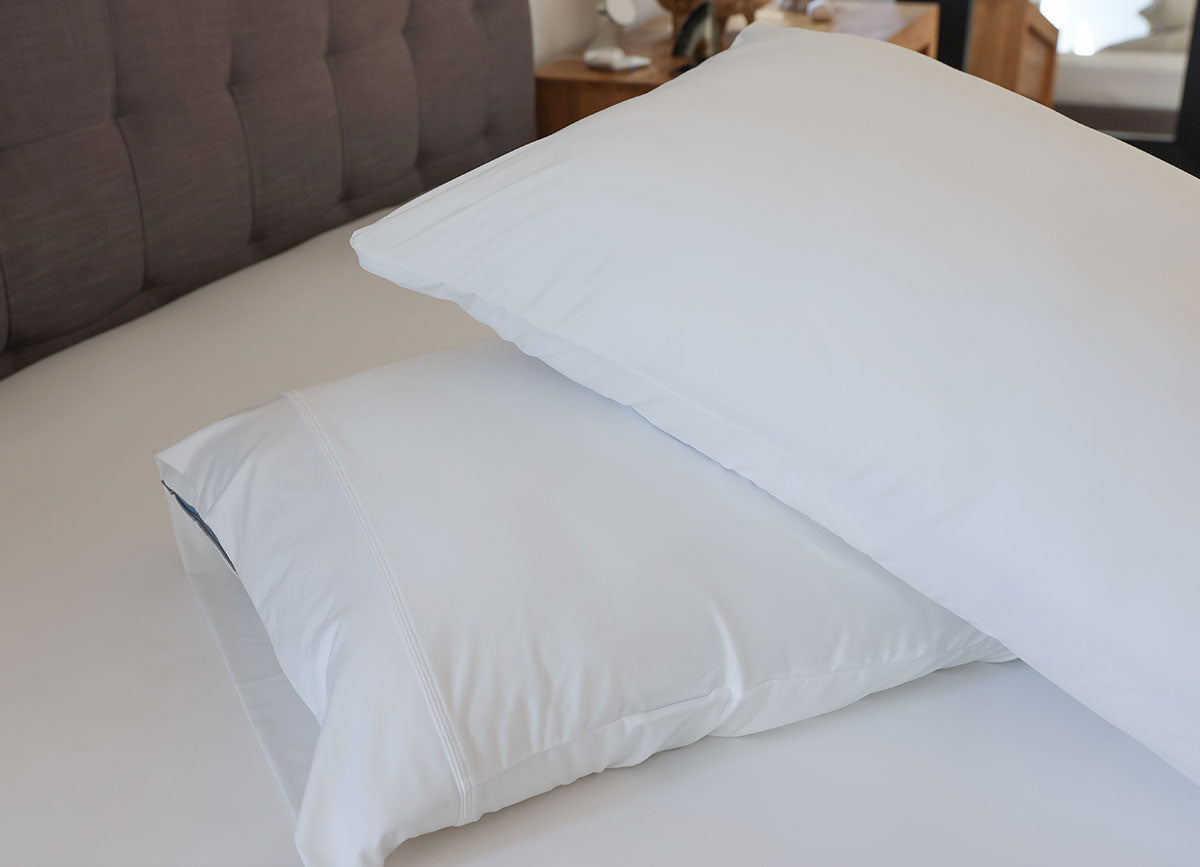 Bright White pillowcases shown on bed in bedroom environment. #choose-your-color_white