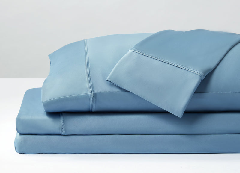 Original Performance Sheet Sets shown in Carolina Blue in stack. #choose-your-color_carolina-blue