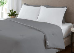 Graphite Original Performance All Season Comforter on a bed.