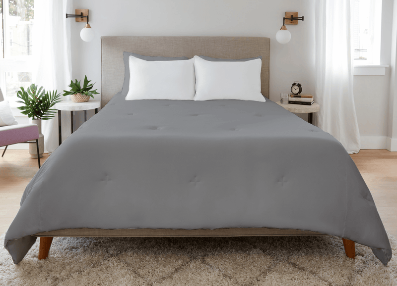 Graphite Original Performance All Season Comforter on a bed.