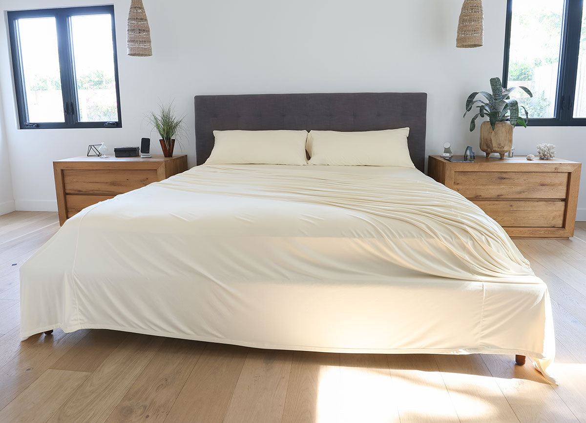 Ecru sheet set shown on bed in bedroom environment. #choose-your-color_ecru