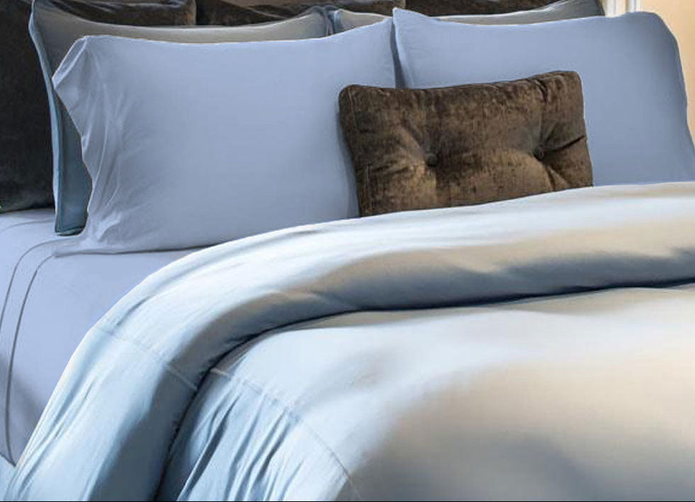 Carolina Blue Pillowcases on a made bed in bedroom