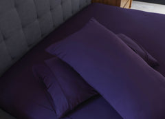 Royal Plum pillowcases shown on bed in bedroom environment. #choose-your-color_royal-plu