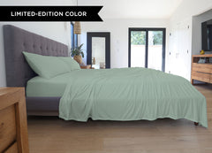 Serene Green sheet set shown on bed in bedroom environment. #choose-your-color_serene-green