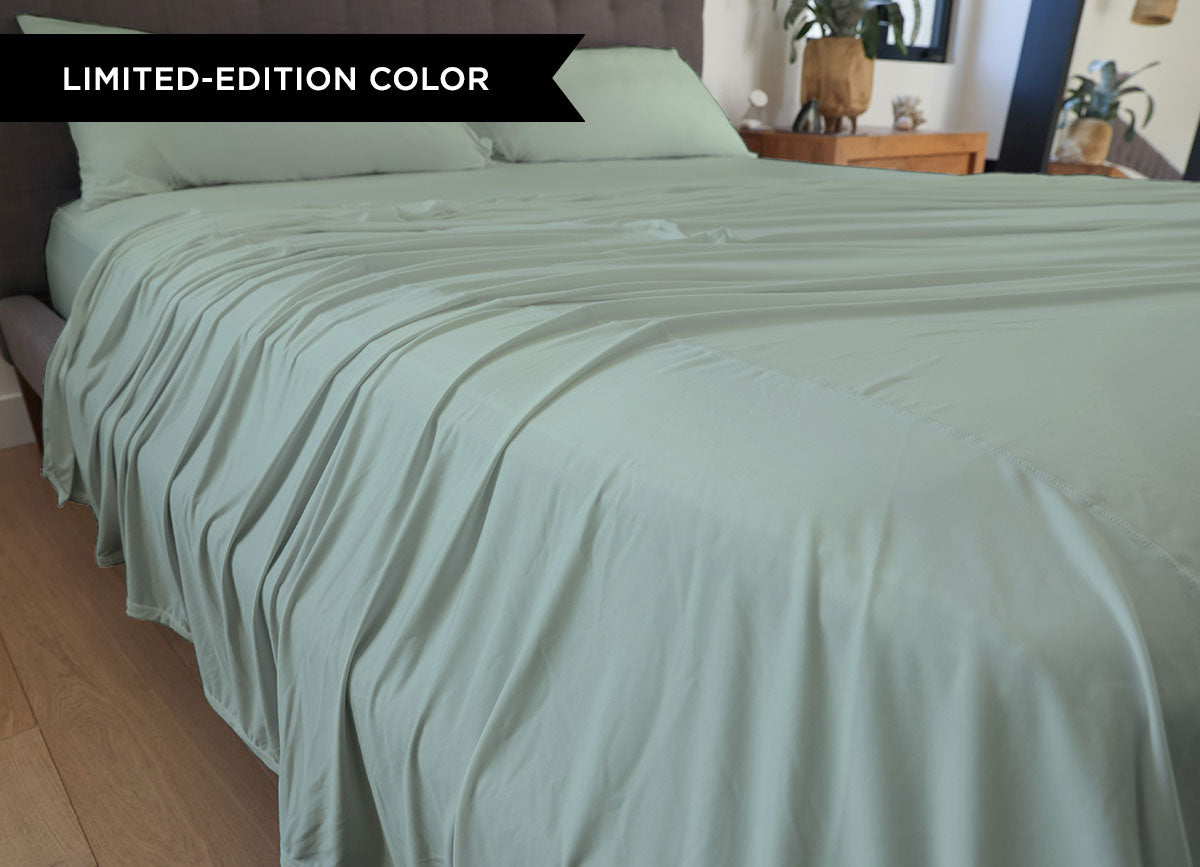 Serene Green sheet set shown on bed in bedroom environment. #choose-your-color_serene-green