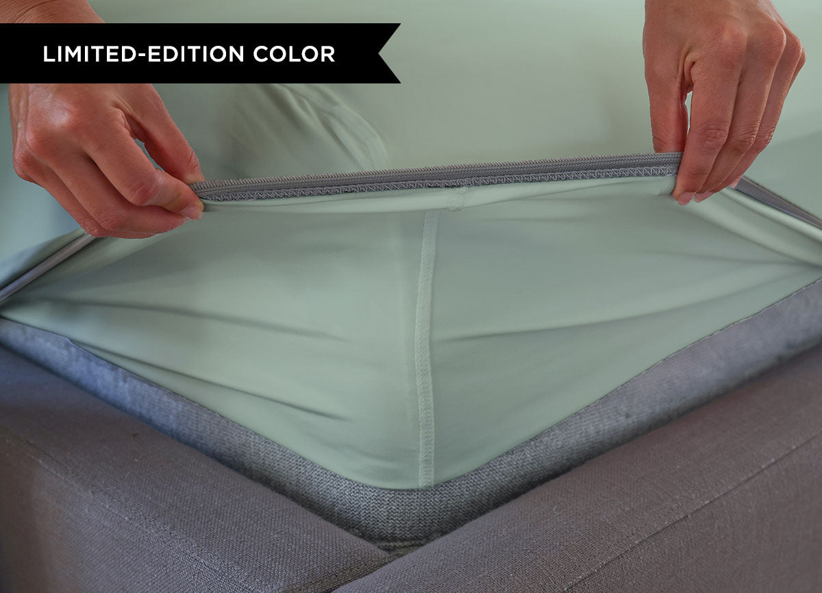 Serene Green sheet set close up of corner with athletic-grade elastic on bed. #choose-your-color_serene-green