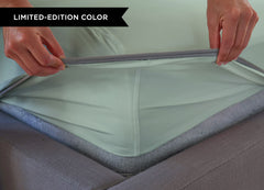 Serene Green sheet set close up of corner with athletic-grade elastic on bed. #choose-your-color_serene-green
