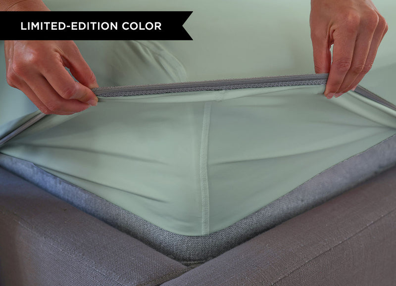 Serene Green sheet set close up of corner with athletic-grade elastic on bed. #choose-your-color_serene-green
