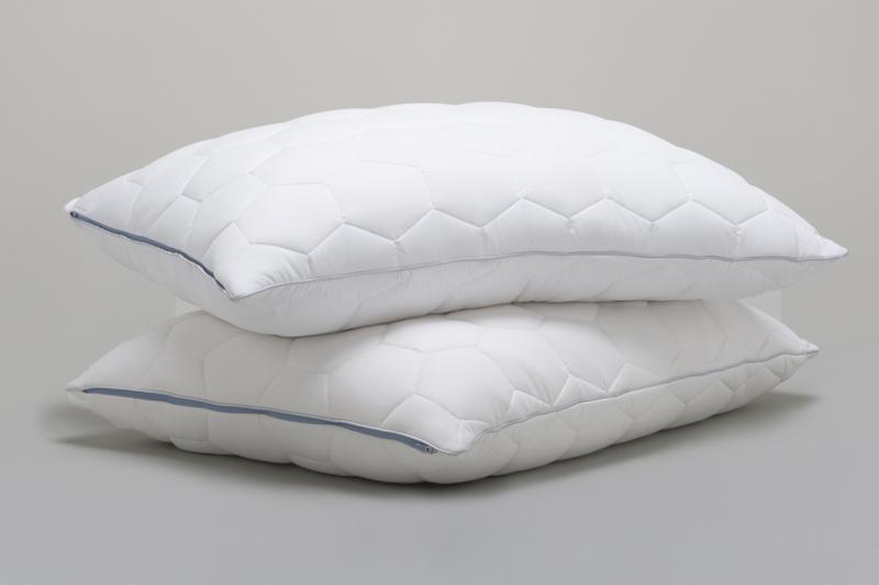 Two Stomach and Back Sleeper Pillows on gray background.