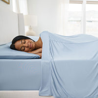 Active Comfort Sheet Set shown on bed with model #choose-your-color_blue-sky