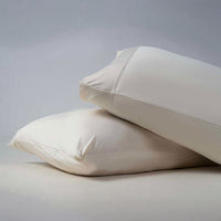 Active Comfort Pillowcases shown on bed #choose-your-color_parchment
