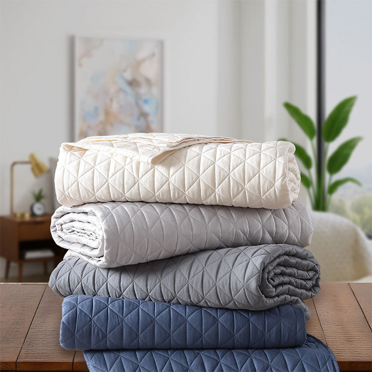 Arctic Diamond Coverlets shown in ivory, silver, charcoal and navy. 