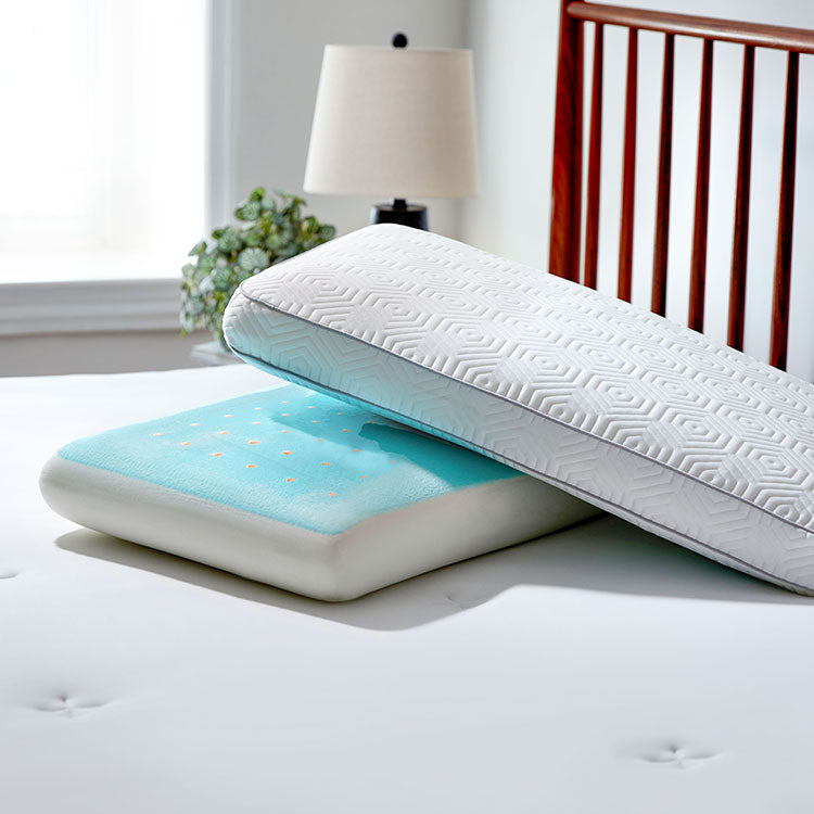 Two Infinite Zen pillows stacked together. Pillow on bottom has cover removed to reveal the grey cooling gel with holes poked in the top which demonstrates cooling and airflow. On a bed.