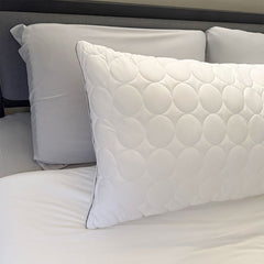 White Nightfall body pillow shown on a bed with other nightfall products.