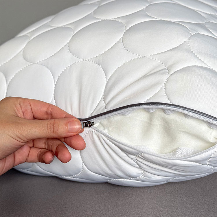 White Nightfall body pillow shown on a bed with a zipper being pulled open to reveal the inner pillow.