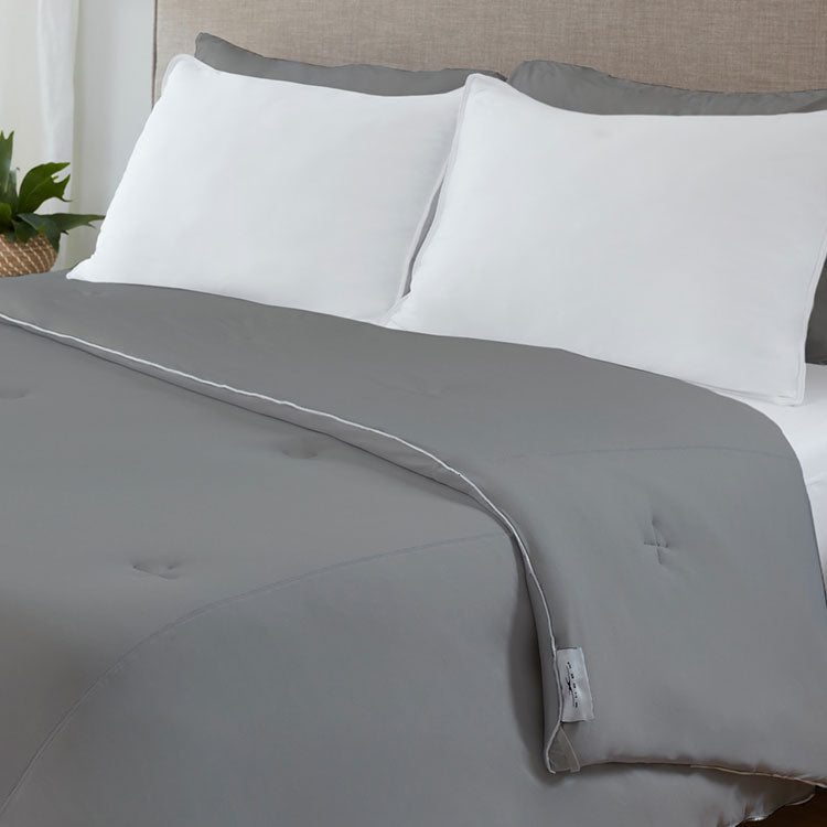 Graphite Original Performance All Season Comforter on a bed. #choose-your-color_graphite