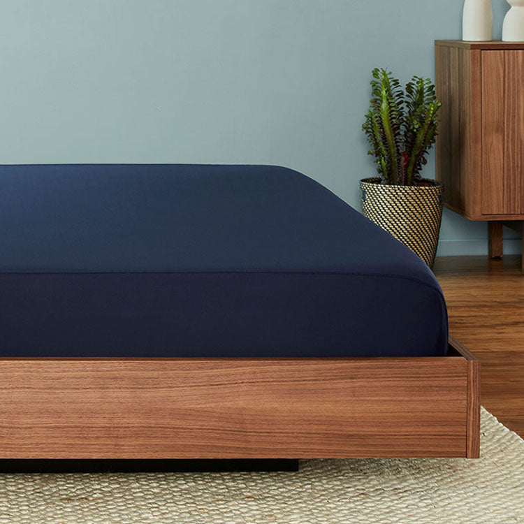 Original Performance Fitted Sheet on bed in Navy #choose-your-color_navy