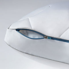 Original Performance Down Alternative Side Sleeper Pillow close up photo showing detail of the blue zipper cover. Shown on a grey and white background.