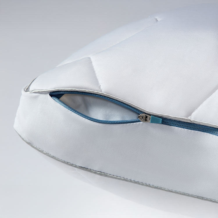 Original Performance Down Alternative Side Sleeper Pillow close up photo showing detail of the blue zipper cover. Shown on a grey and white background.