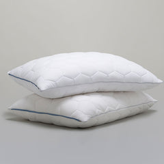 Two SHEEX Stomach/Back Down Alternative Pillows stacked shown on a grey background.