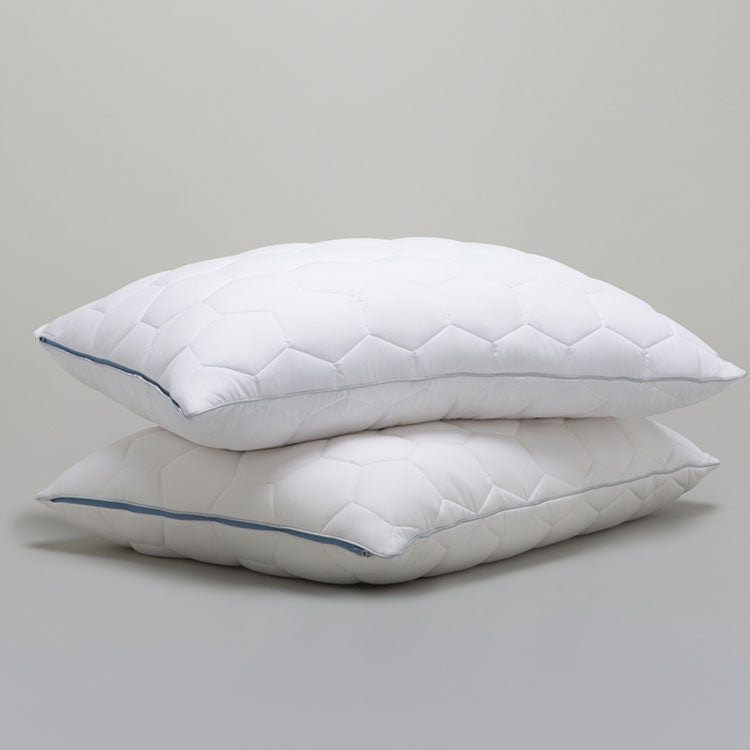 Two SHEEX Stomach/Back Down Alternative Pillows stacked shown on a grey background.