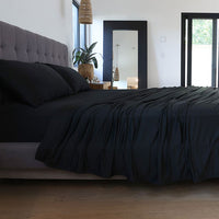 Black sheet set shown on bed in bedroom environment. #choose-your-color_black