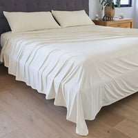 Ecru sheet set shown on bed in bedroom environment. #choose-your-color_ecru