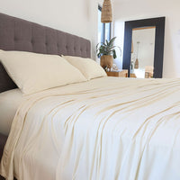 Ecru sheet set shown on bed in bedroom environment. #choose-your-color_ecru