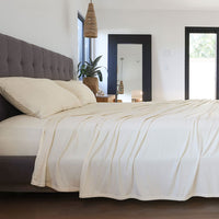 Ecru sheet set shown on bed in bedroom environment. #choose-your-color_ecru