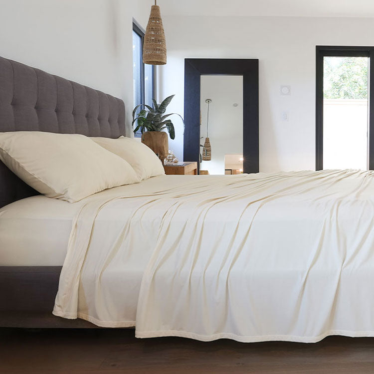 Ecru sheet set shown on bed in bedroom environment. #choose-your-color_ecru