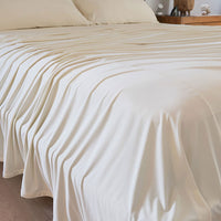 Ecru sheet set shown on bed in bedroom environment. #choose-your-color_ecru