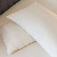 Ecru sheet pillowcase pair shown on bed in bedroom environment. #choose-your-color_ecru