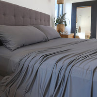 Graphite sheet set shown on bed in bedroom environment. #choose-your-color_graphite
