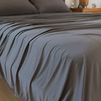 Graphite sheet set shown on bed in bedroom environment. #choose-your-color_graphite