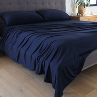 Navy Blue sheet set shown on bed in bedroom environment. #choose-your-color_navy
