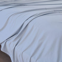 Pearl Blue sheet set shown on bed in bedroom environment. #choose-your-color_pearl-blue