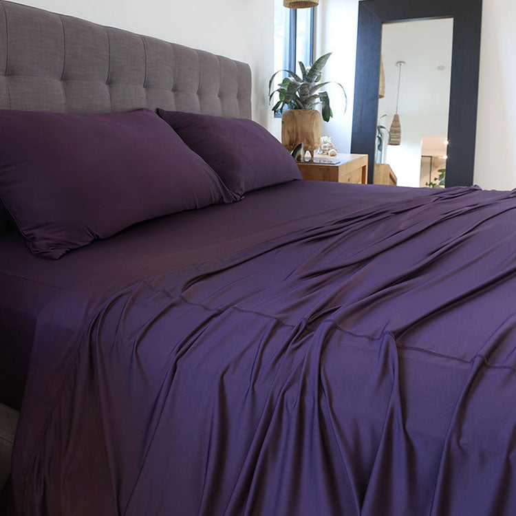 Royal Plum sheet set shown on bed in bedroom environment. #choose-your-color_royal-plum