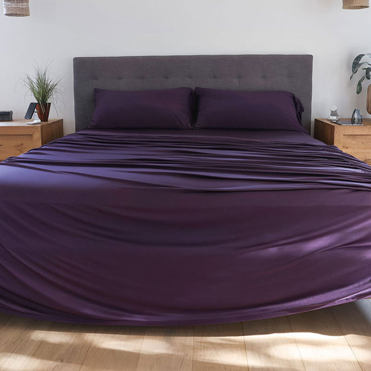 Royal Plum sheet set shown on bed in bedroom environment. #choose-your-color_royal-plum