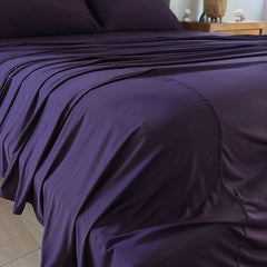 Royal Plum sheet set shown on bed in bedroom environment. #choose-your-color_royal-plum