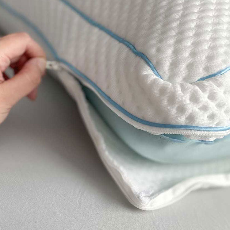 SHEEX Versa Cloud Pillow being zipped closed with blue cooling foam showing and down alternative fiber fill on top the foam - on grey background.