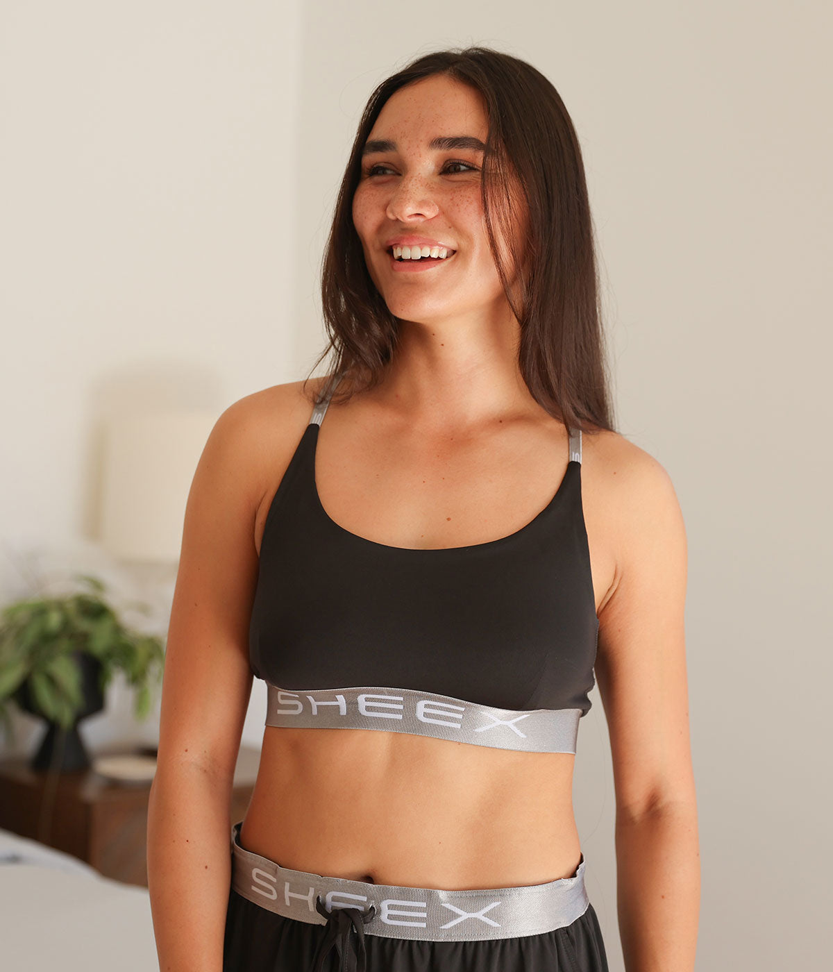 Model wearing the SHEEX Women's Bra Top in Black #choose-your-color_black