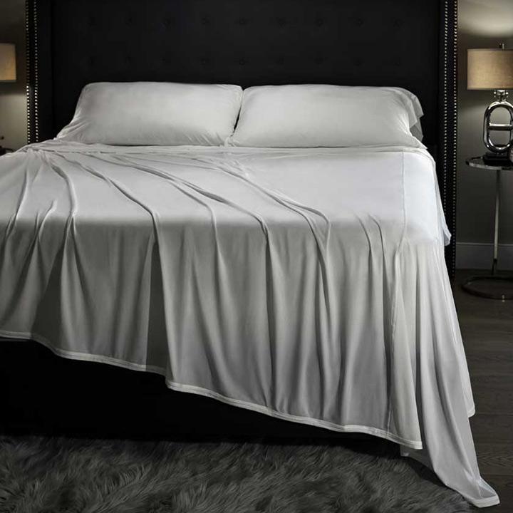 Midnight Label Sheet Set in Mist Gray shown on bed.