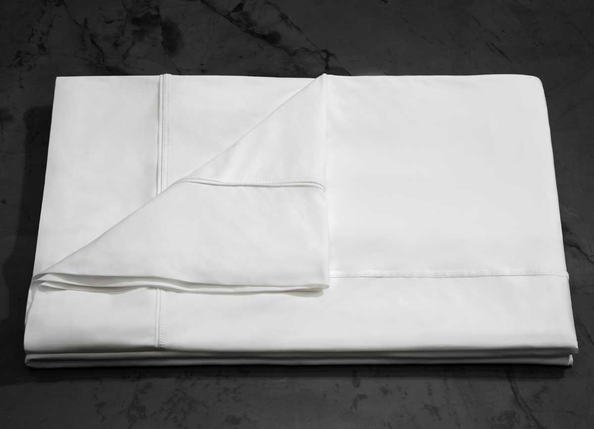 MIDNIGHT LABEL Flat Sheet shown in porcelain folded #choose-your-color_porcelain
