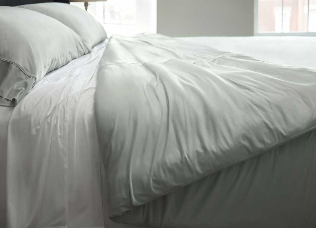 Lifestyle of Midnight Label Duvet Cover shown on bed in Mist Gray #choose-your-color_mist-gray