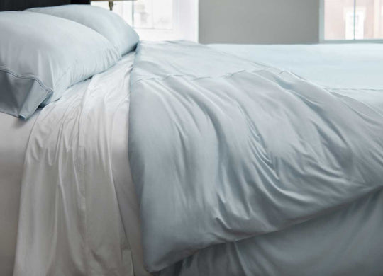 Lifestyle of Midnight Label Duvet Cover shown on bed in Spa Blue #choose-your-color_spa-blue